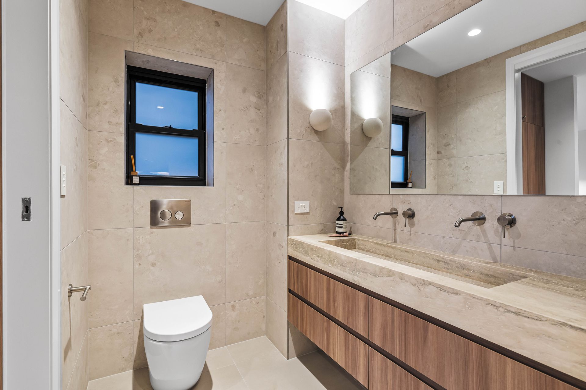 Bathroom - natural stone vanity and wall-mounted taps