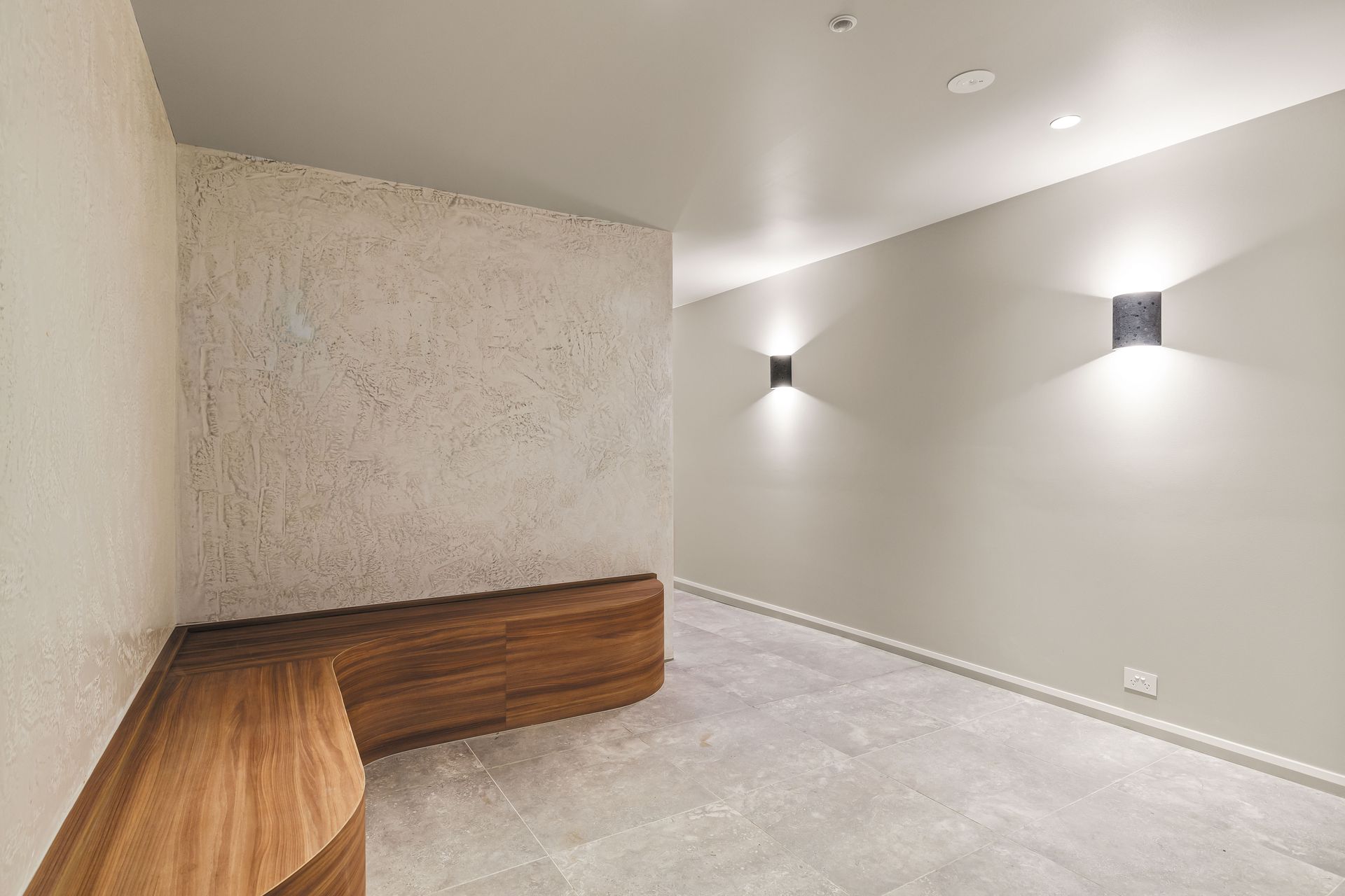 Lobby entrance with timber bench and textured wall